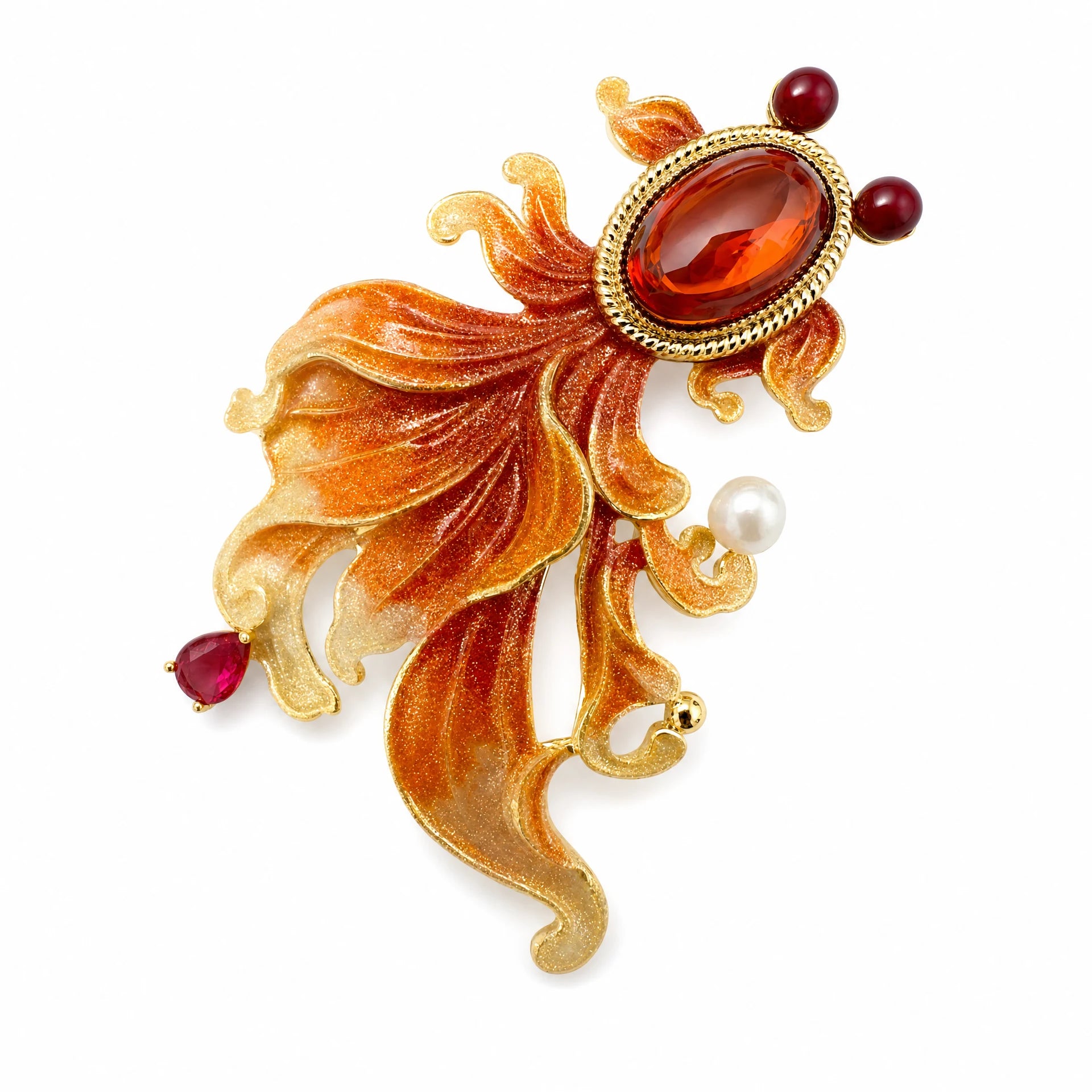 Orange enamel goldfish brooch with amber crystal body and flowing red tail on a white background