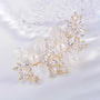 Close-up of translucent white flower petals, pearl accents and clear marquise crystals