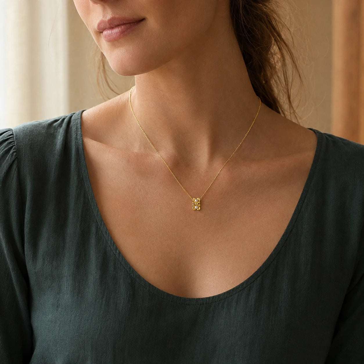Model wearing gold-tone double flower pendant necklace with white pearl-style centres