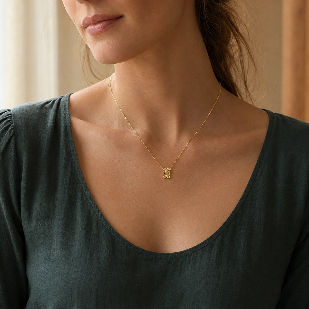 Model wearing gold-tone double flower pendant necklace with white pearl-style centres
