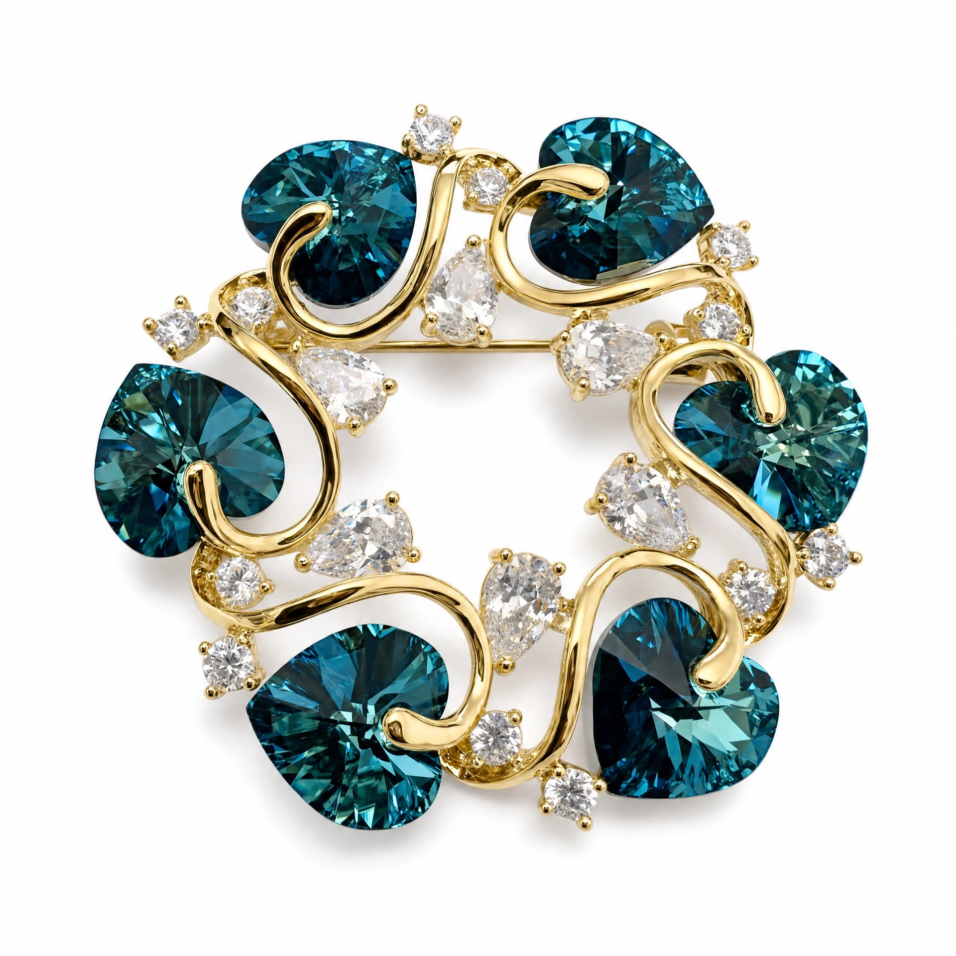 Gold tone teal heart crystal vine brooch on a white background