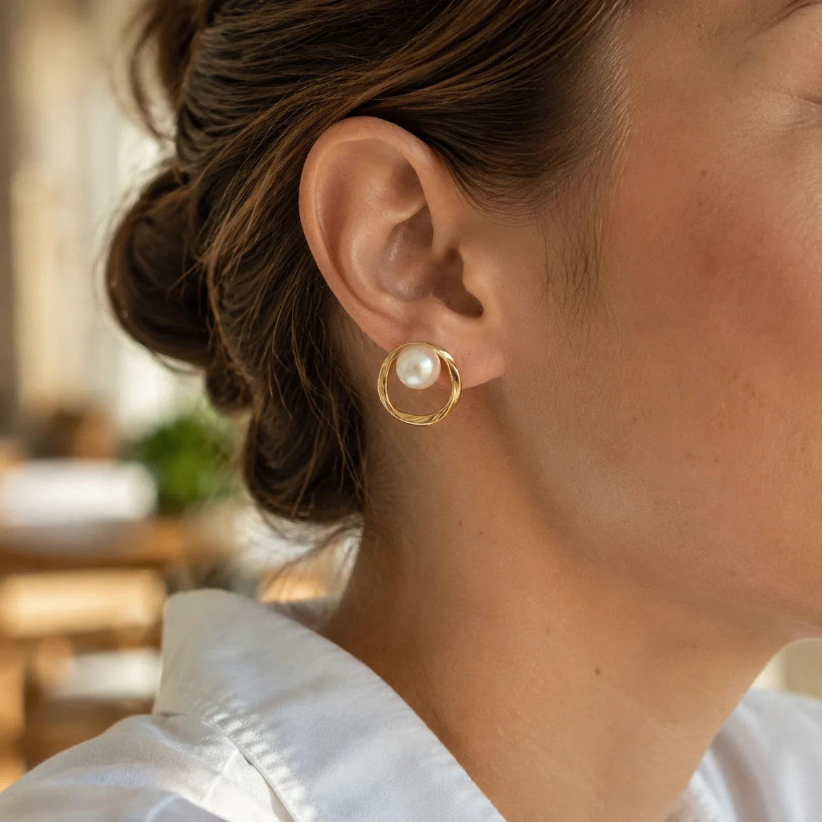 Model wearing gold-tone organic circle freshwater pearl stud earrings