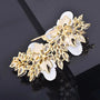 Back of white floral crystal pearl brooch with gold-tone secure pin fastening