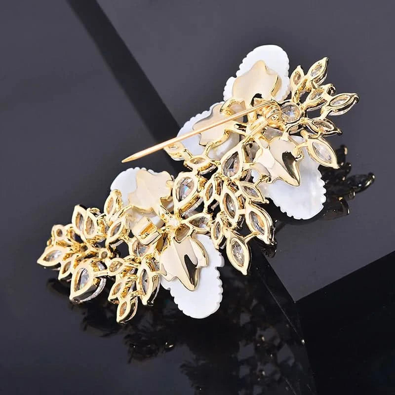 Back of white floral crystal pearl brooch with gold-tone secure pin fastening