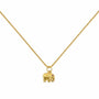 Gold-tone elephant pendant necklace with an upturned trunk and red stone accent