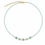 Amazonite beaded necklace with five carved flowers and freshwater pearl accents on a white background