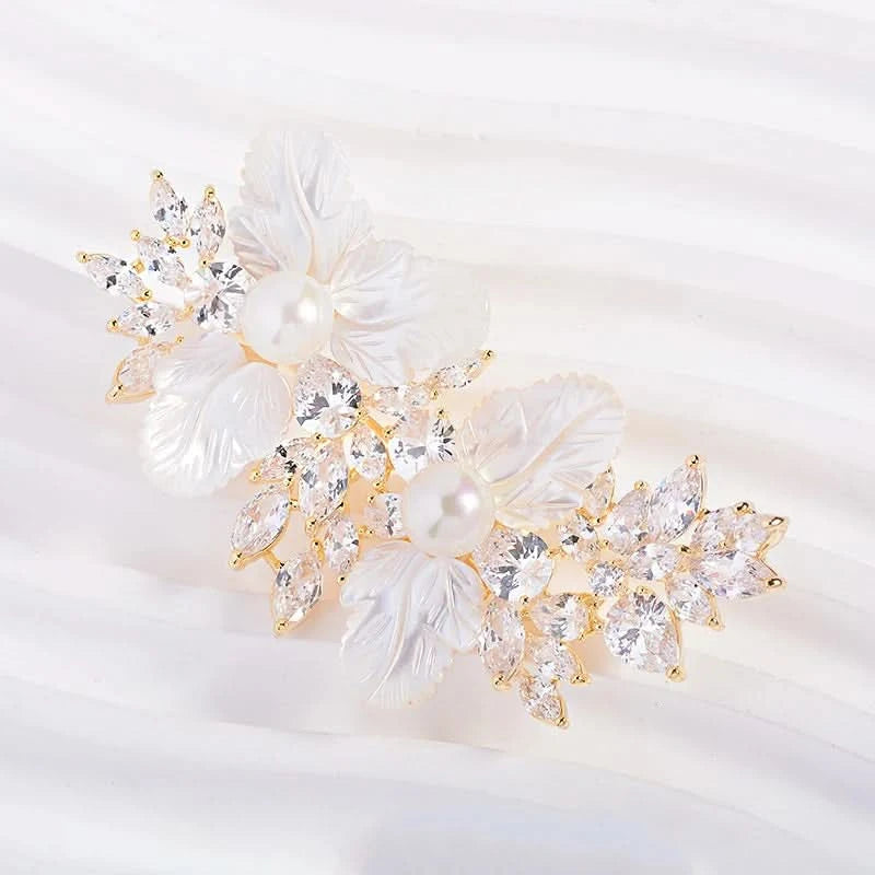 White floral brooch with sculpted petals, clear crystal sprays and pearl-effect centres