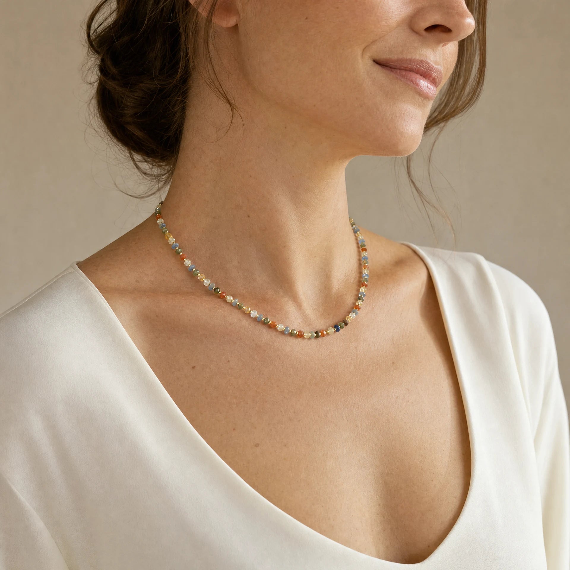 Pastel mixed natural gemstone necklace worn at a three quarter angle