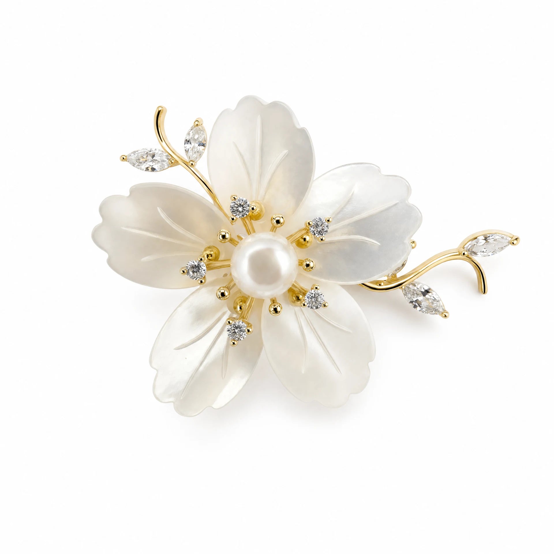 Mother-of-pearl flower brooch with pearl centre and gold-tone crystal branches on a white background