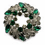 Emerald Green crystal leaf wreath brooch on a white background