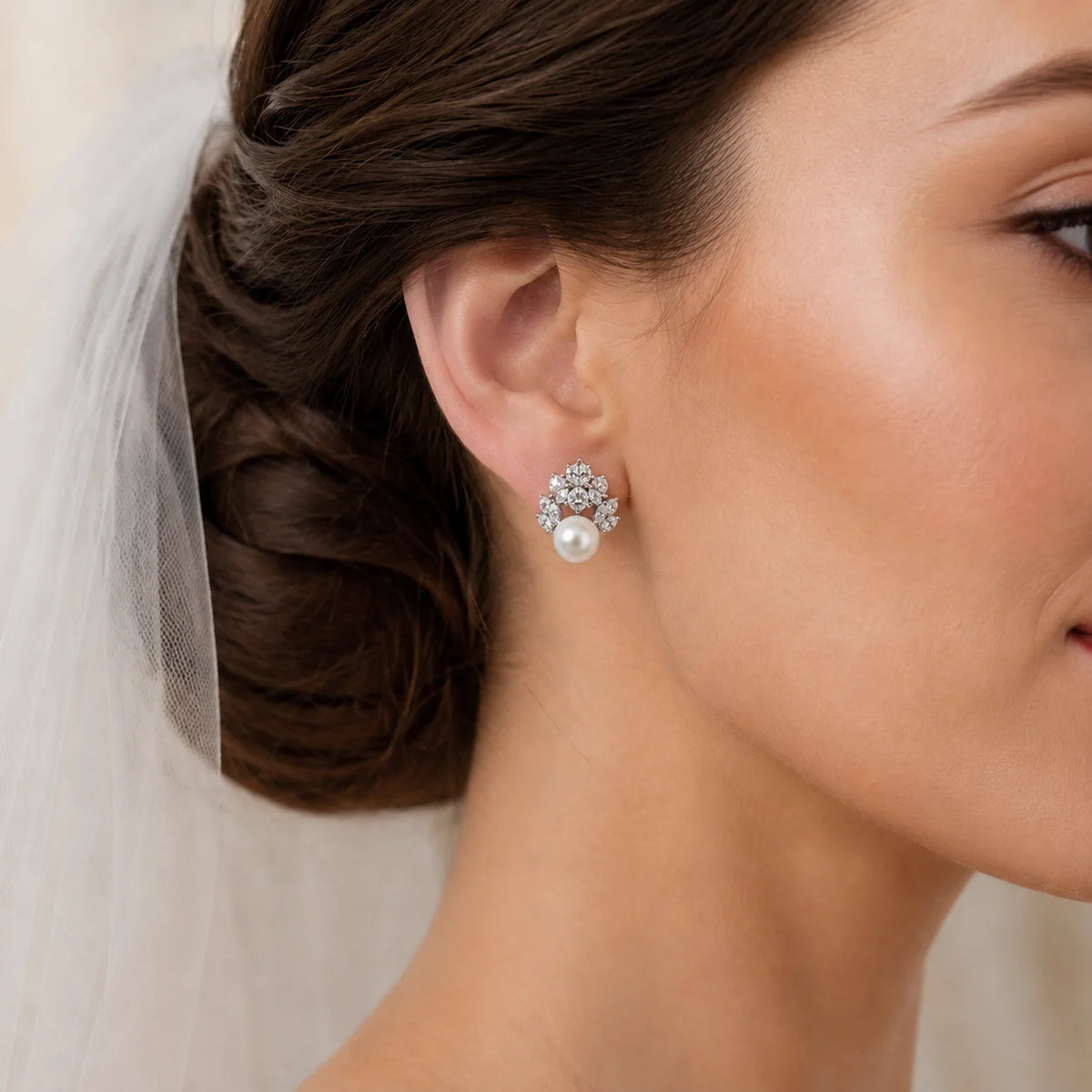 Bride wearing silver-tone freshwater pearl floral cluster stud earrings with clear zircon petals